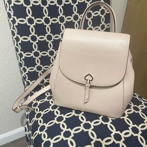 Small Kate spade beige color backpack really pretty for the price. 💜💜